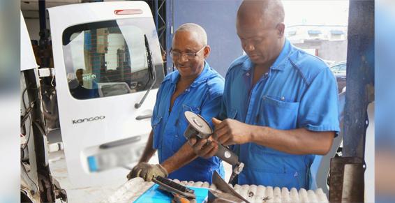 Deux hommes en combinaison bleue côte à côte.