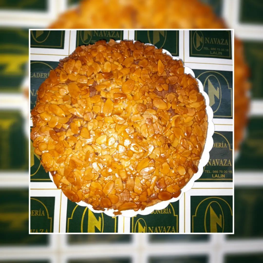 Un pastel redondo coronado con láminas de almendras