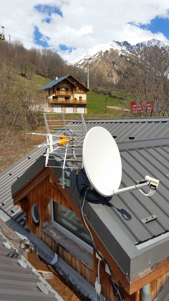 Parabole et râteau positionnés sur un chalet
