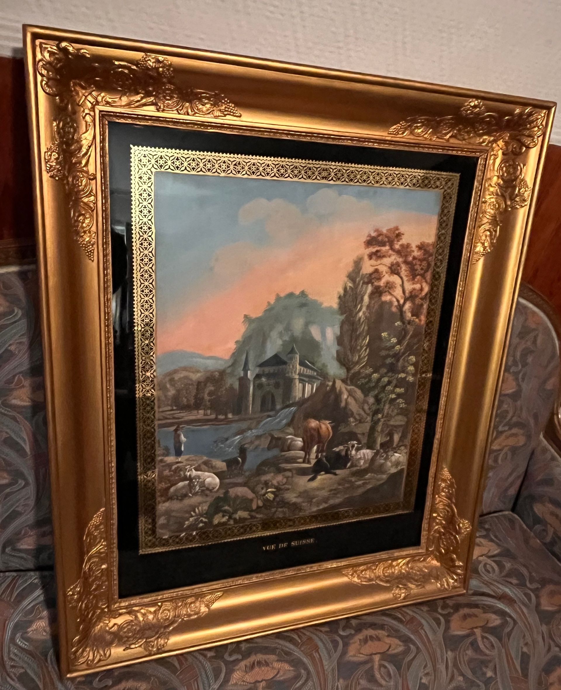 Tableau avec cadre doré représentant un paysage avec une château fort