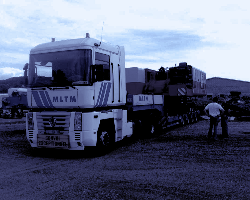 Deux hommes discutent devant un engin de convoi exceptionnel