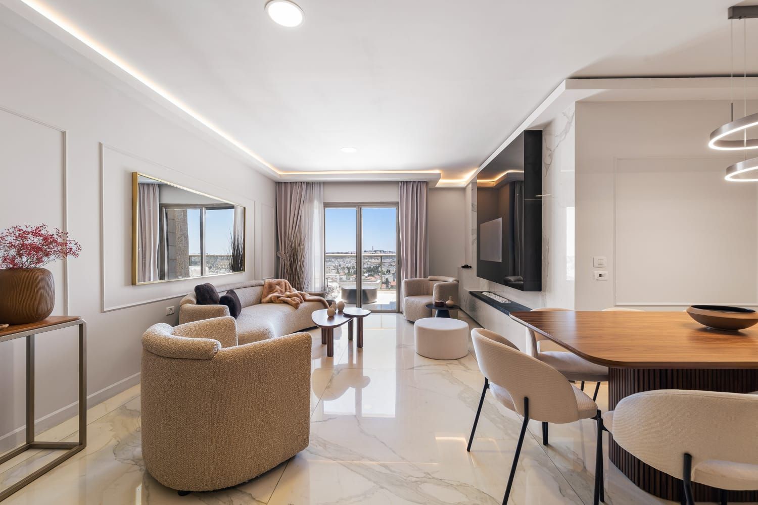 A living room with a couch , chairs , a table and a television.