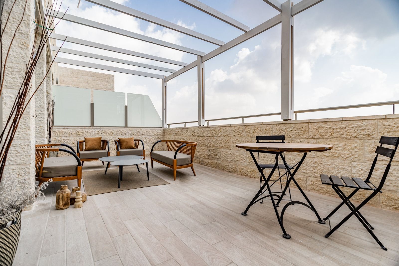 A patio with a table and chairs under a canopy.