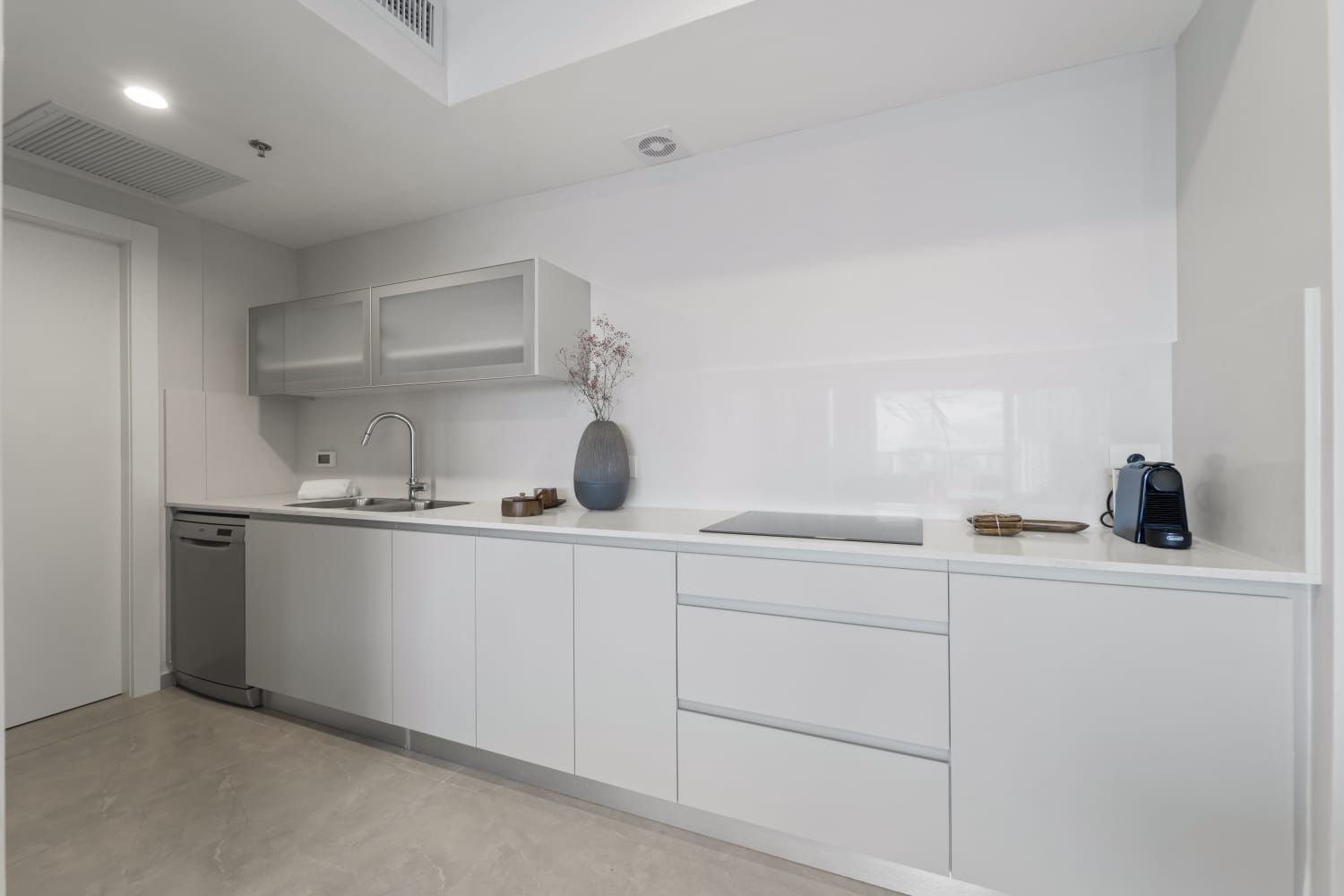 A kosher kitchen with white cabinets , a sink , and a dishwasher. luxury airbnb jerusalem