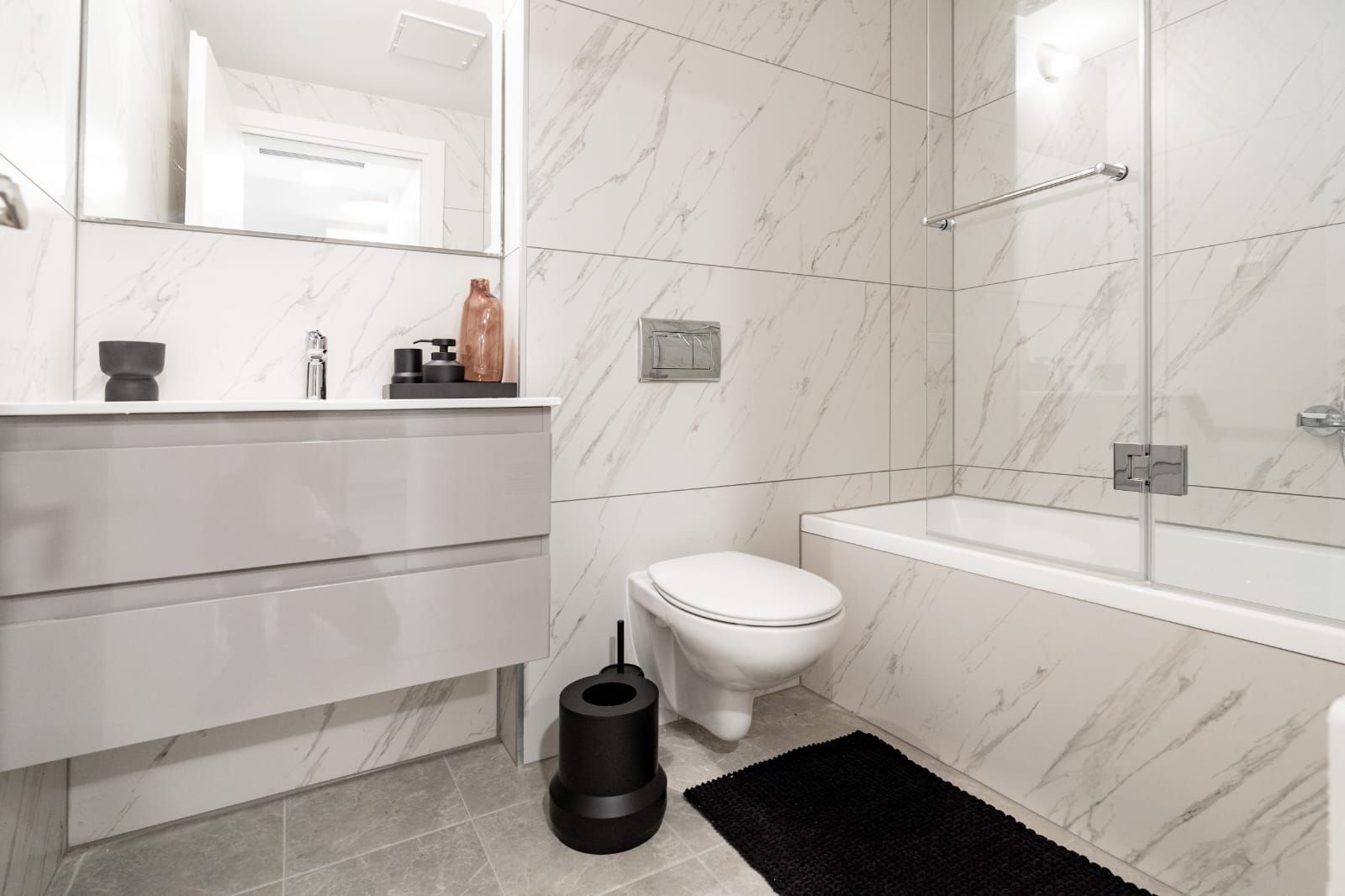 A bathroom with a toilet , sink , and bathtub.