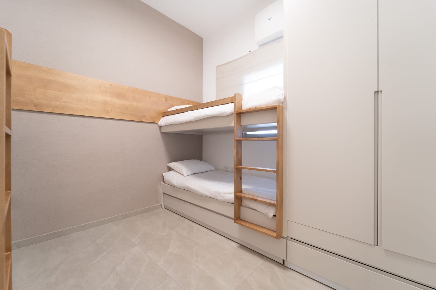 A bedroom with two bunk beds and a ladder. Kosher airbnb Jerusalem