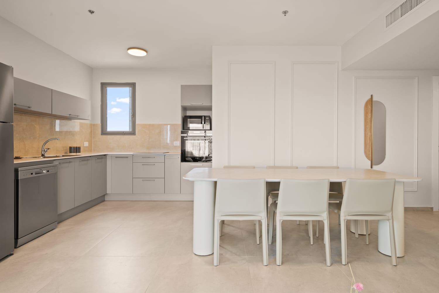 A kitchen with a table and chairs in it.