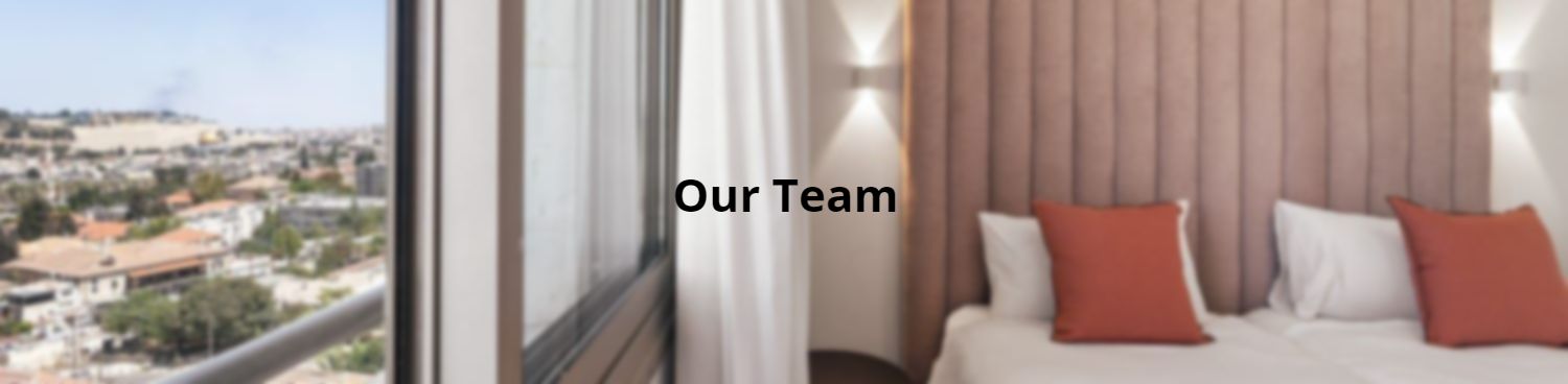 A hotel room with a bed and a window with the words `` our team '' written on it.