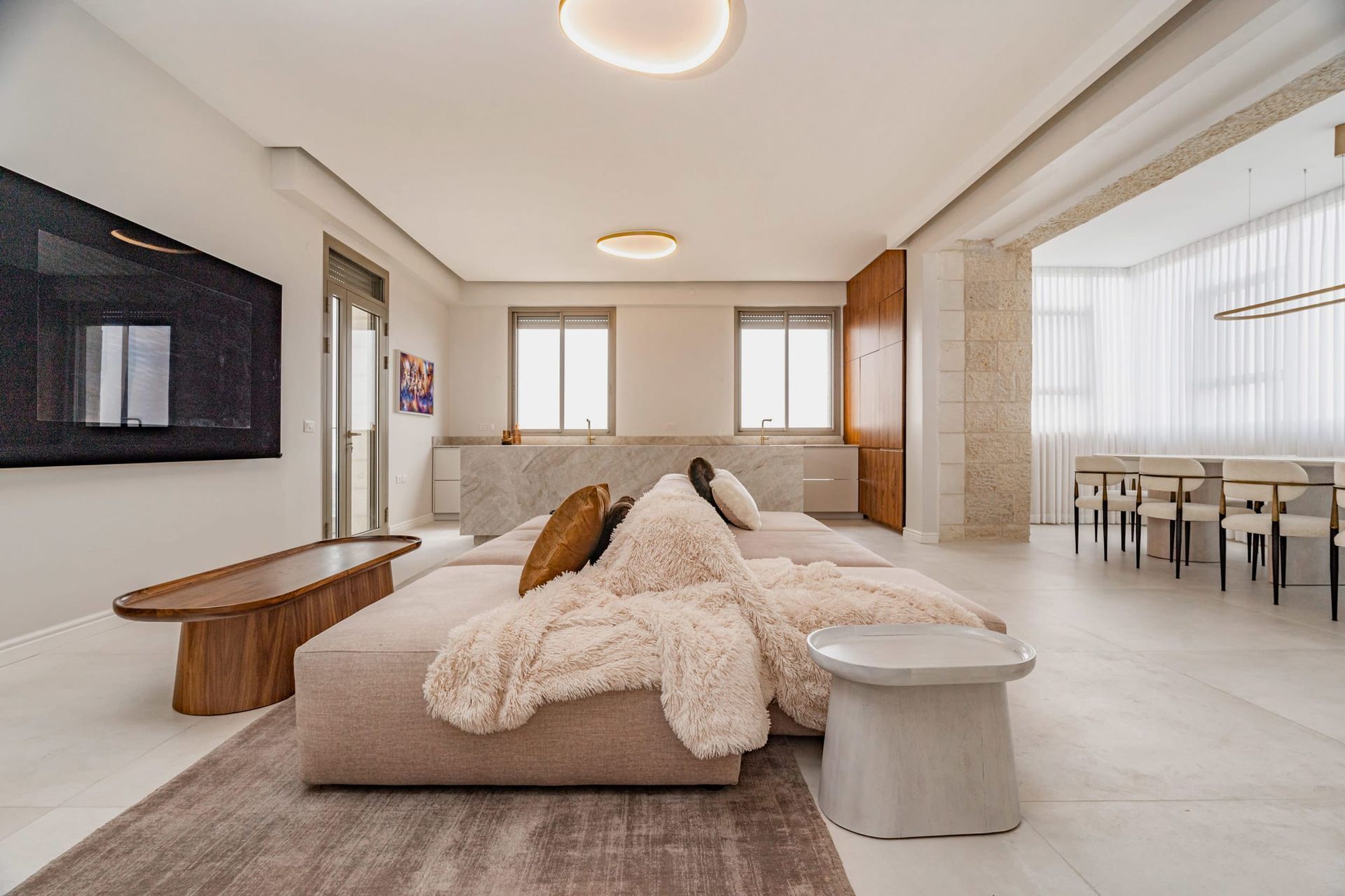 A living room with a couch , table , and television.