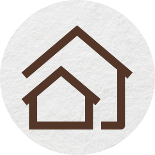 An icon of two houses in a circle on a white background.