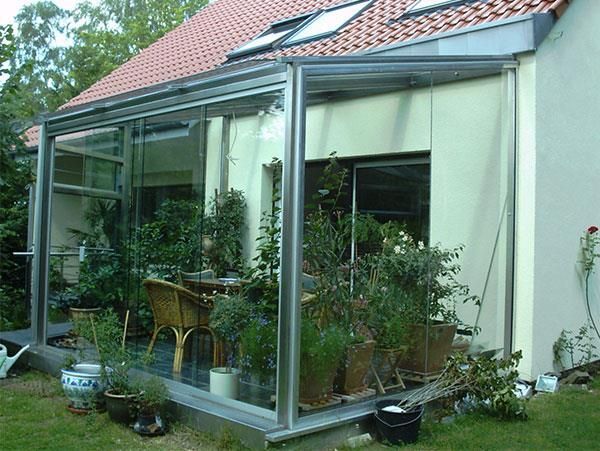 Ein Haus mit einer Terrasse mit einem Tisch und Stühlen darauf