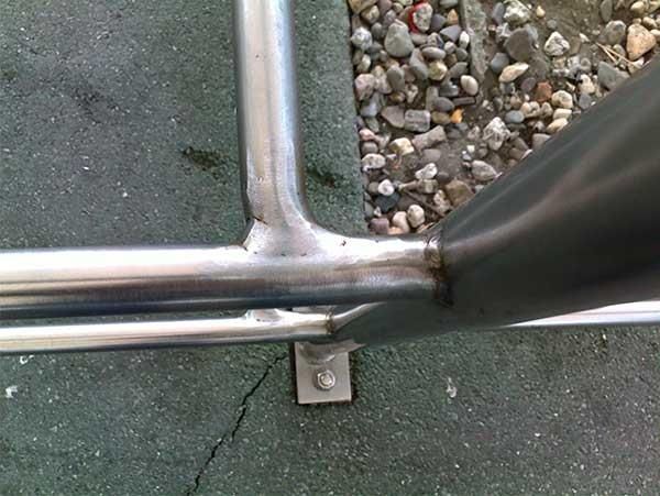 Ein Metallrohr liegt neben einem Steinhaufen auf dem Boden.