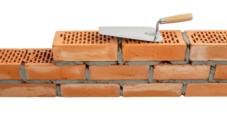 Une truelle posée sur un mur de briques en cours de construction, avec des joints de mortier visibles.