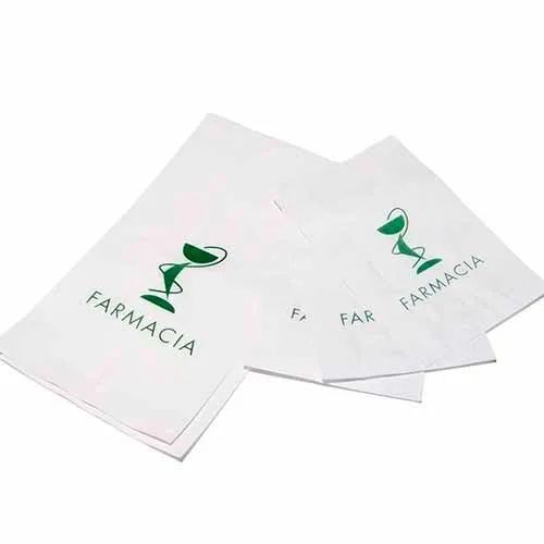 Una bolsa de papel blanca con la palabra farmacia escrita en ella.