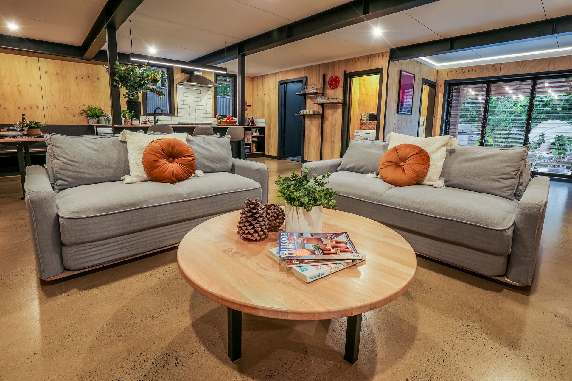 A living room with two couches and a round coffee table.