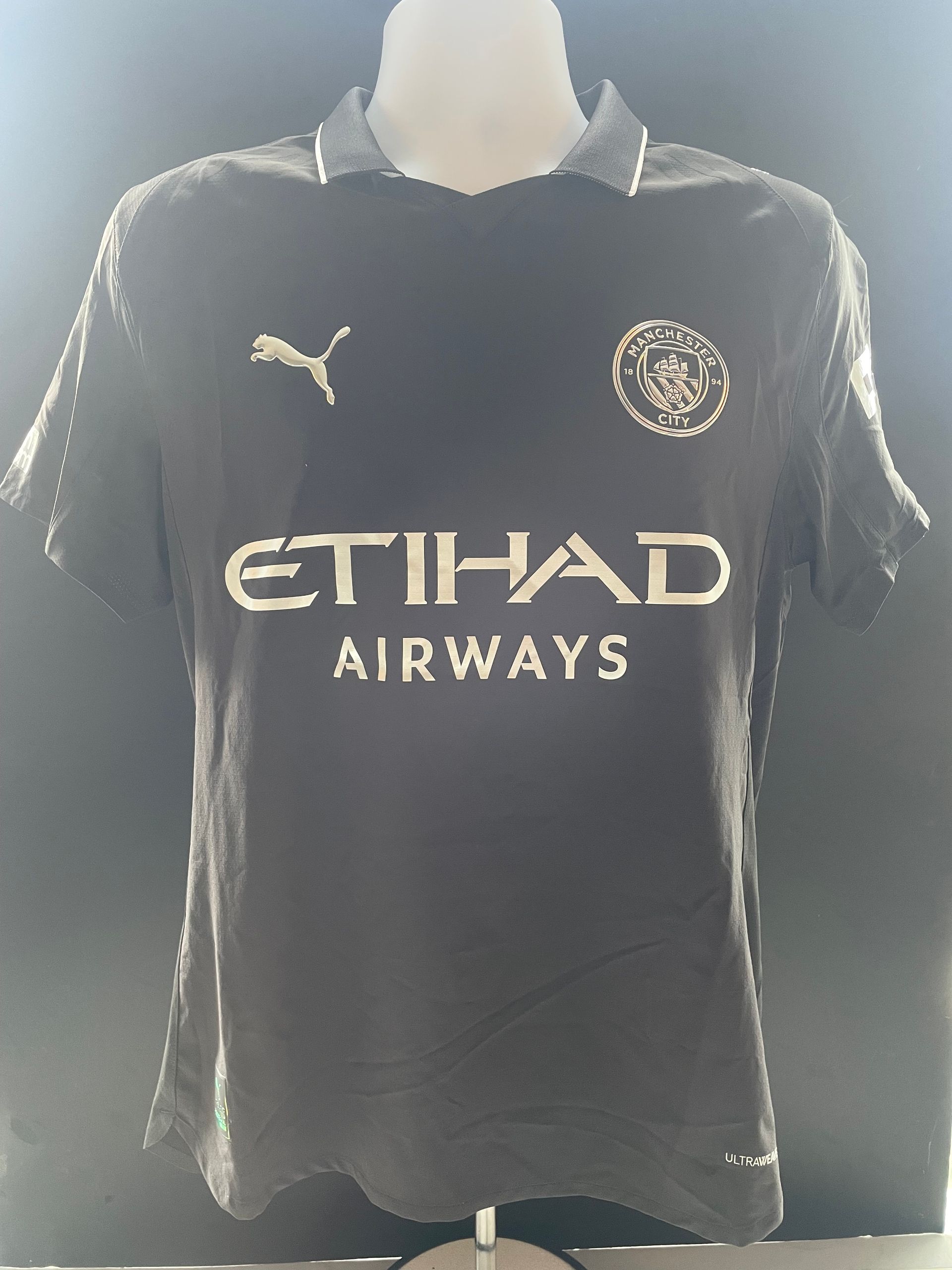 Black sports jersey with “LEWIS” and number 82 on the back.