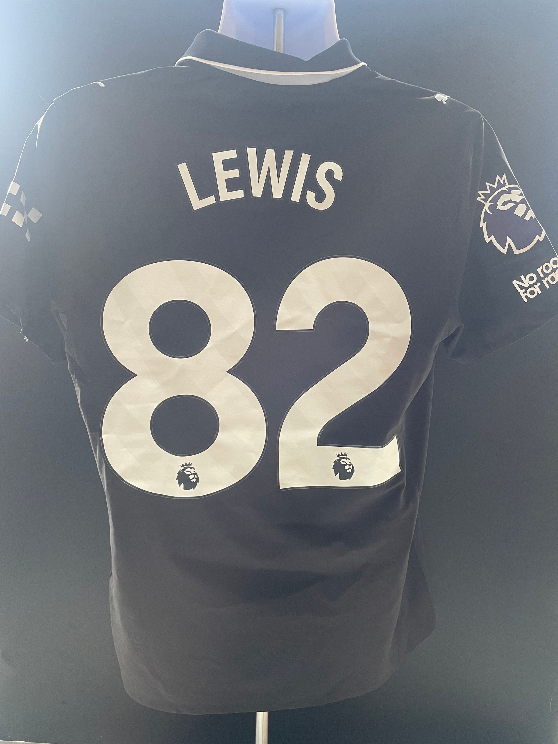 Black sports jersey with “LEWIS” and number 82 on the back.