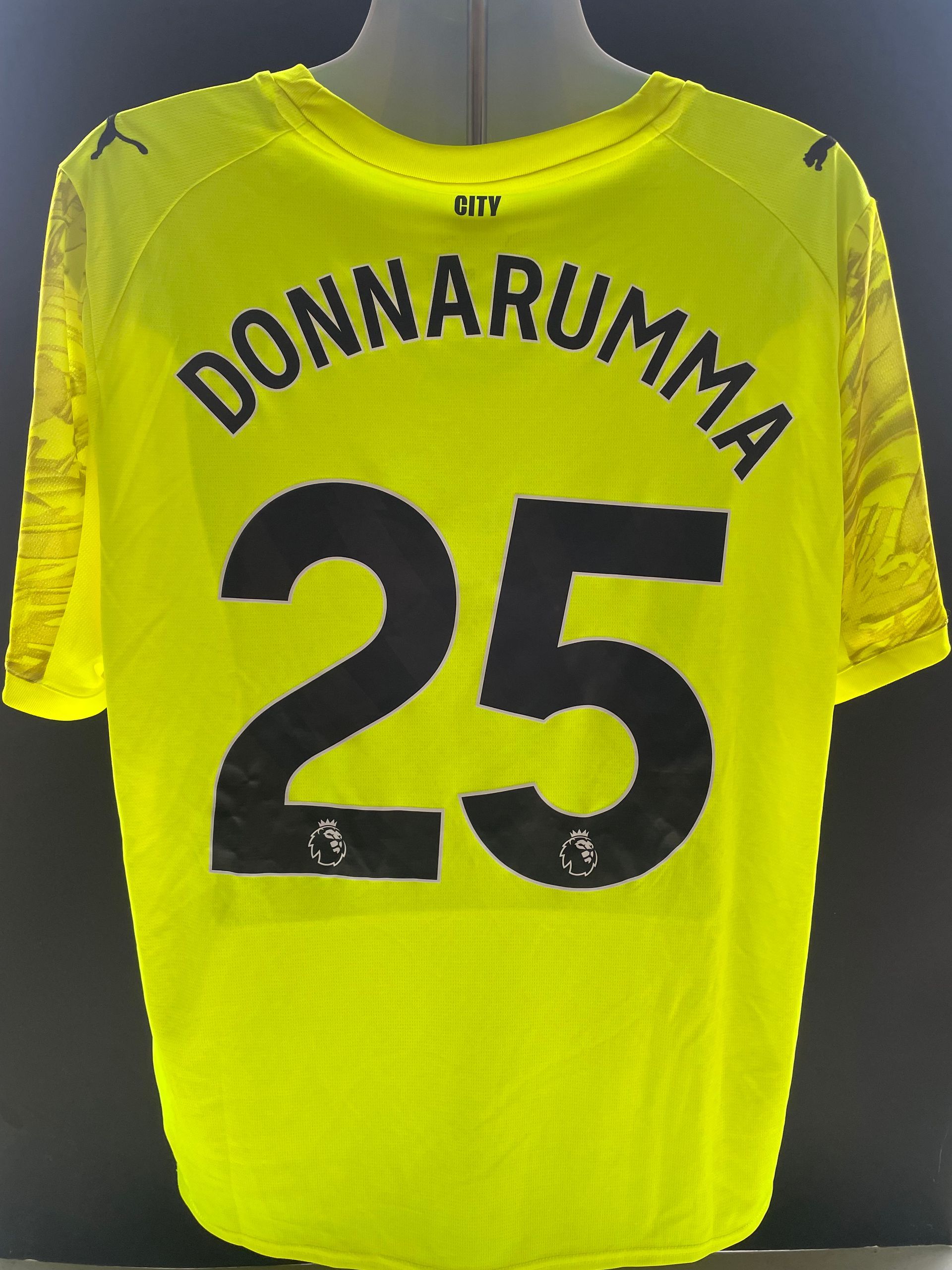 Bright yellow soccer jersey with “Donnarumma” and number 25 on the back