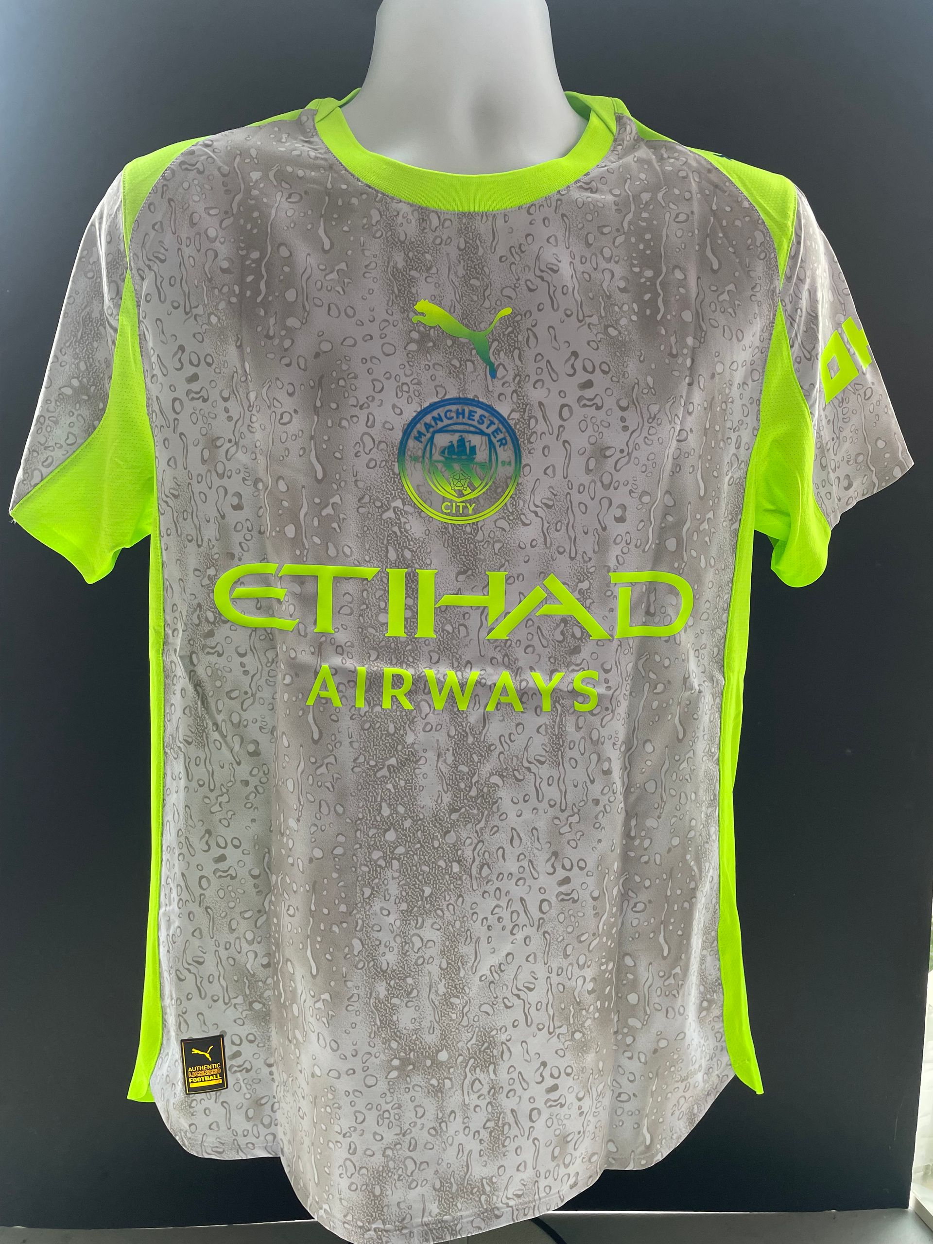 Gray soccer jersey with neon green accents, “BERNARDO” and number 20 on the back.