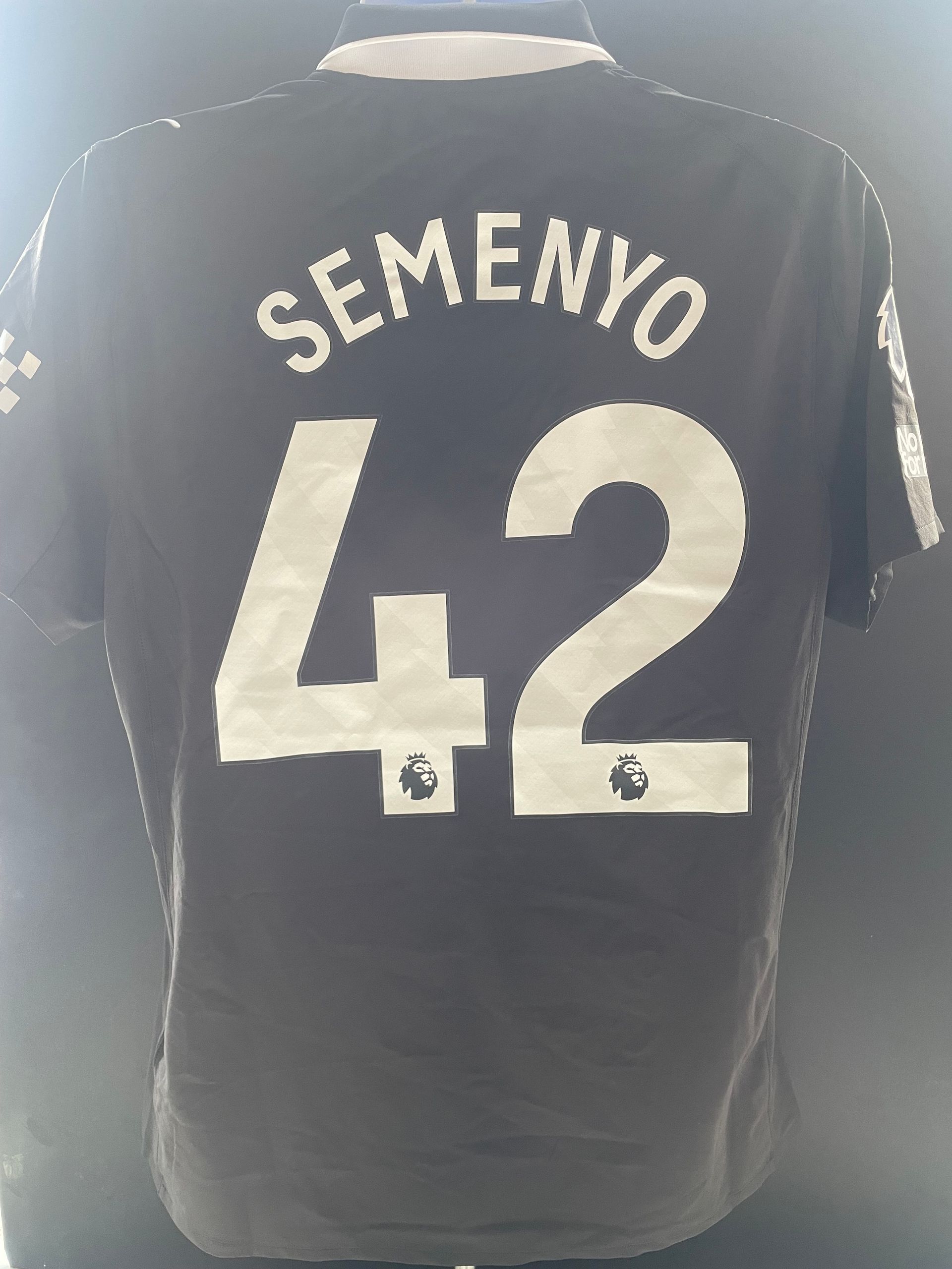 Black sports jersey with white “SEMENYO” and number 42 on the back