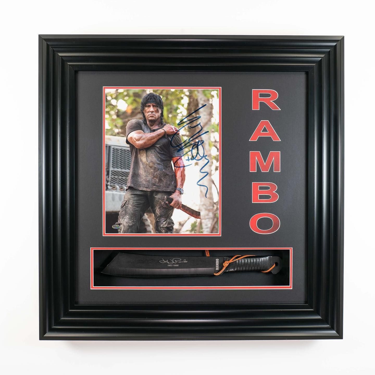 Framed, hand-signed photograph of Sylvester Stallone accompanied by a replica machete from the 2004 film Rambo IV