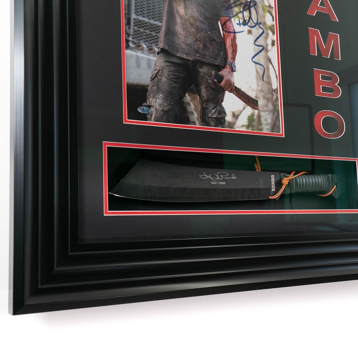 Framed, hand-signed photograph of Sylvester Stallone accompanied by a replica machete from the 2004 film Rambo IV