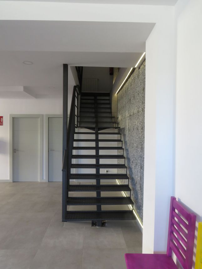 Un dormitorio con mesa, espejo y lámpara.