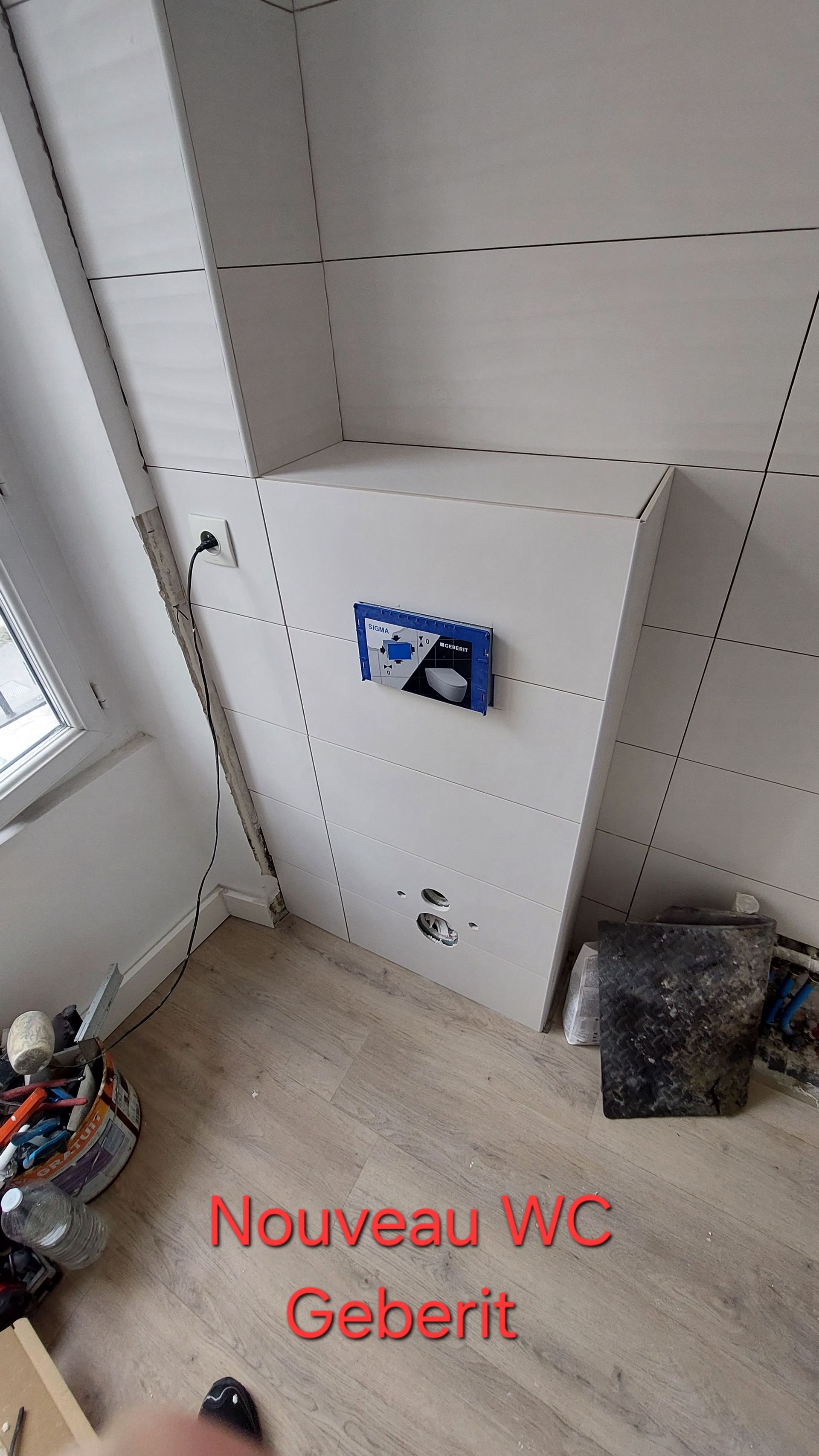 Installation de toilettes neuves avec mécanisme de chasse d'eau Geberit. Murs blancs, parquet, outillage apparent.
