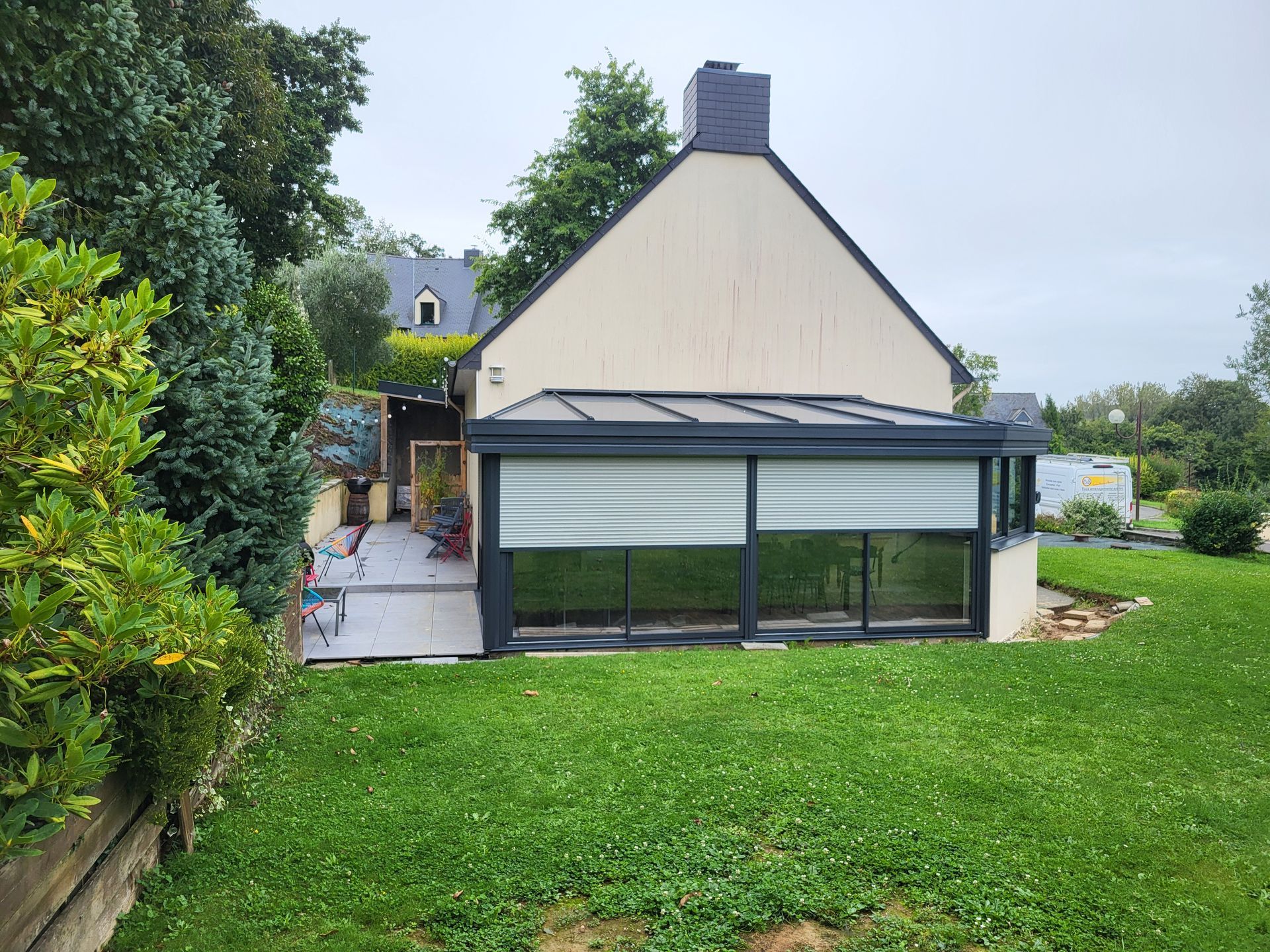 Véranda en aluminium avec les volets entrouvert