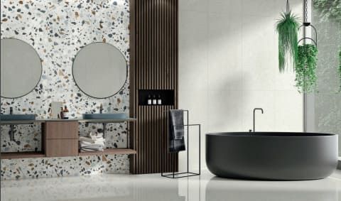 Un baño con bañera, lavabos y espejos.