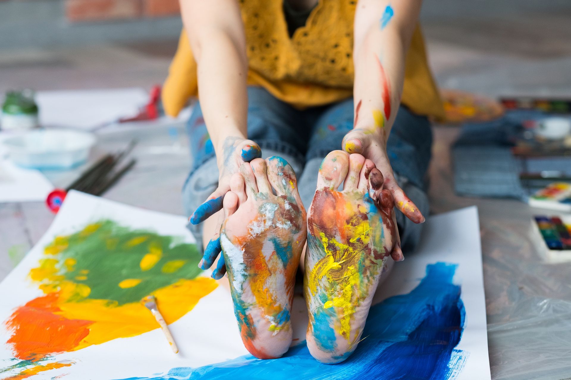 Enfant avec de la peinture sur les pieds signifiant un atelier créatif