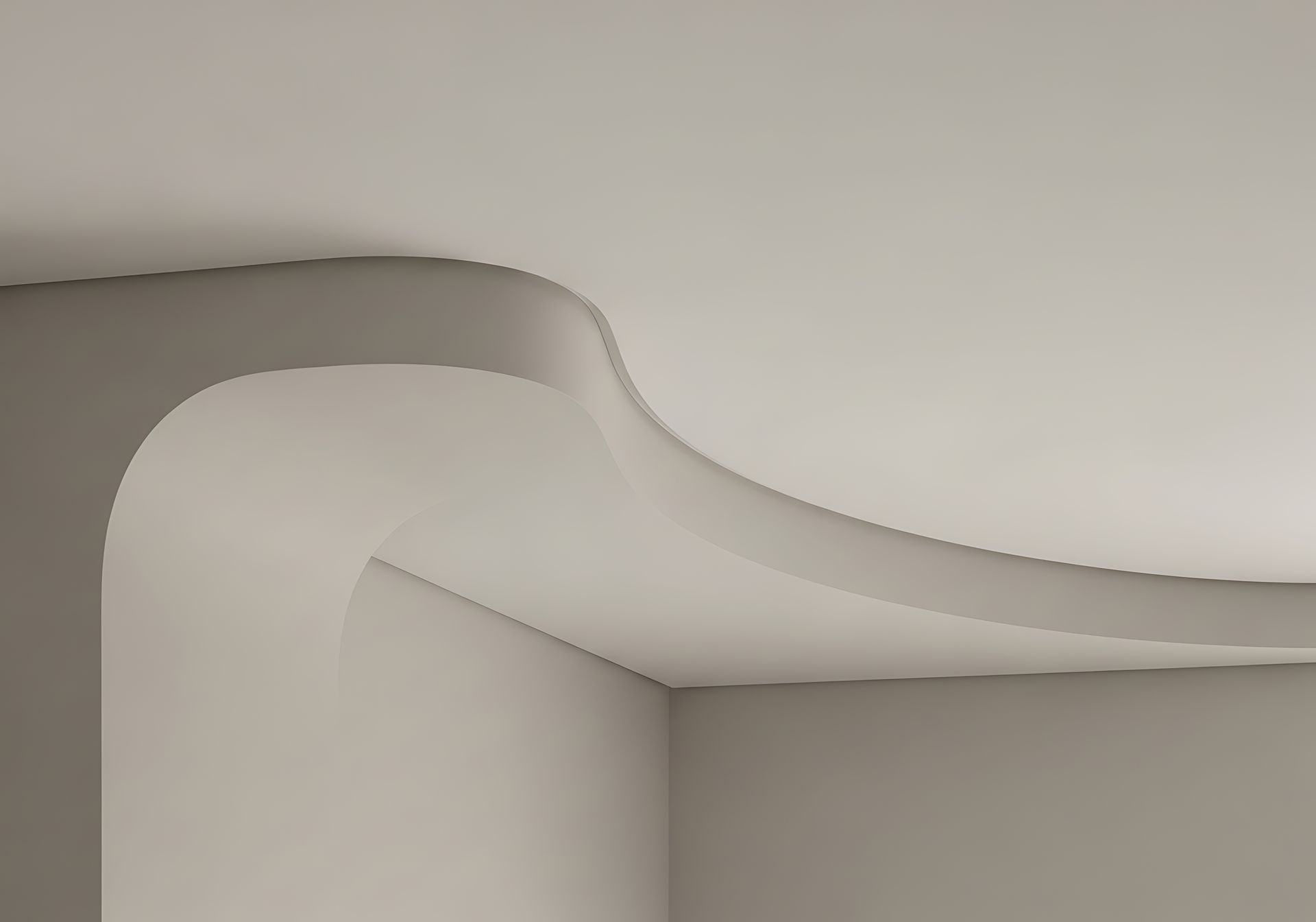 Détail architectural minimaliste montrant un angle de plafond incurvé rejoignant un mur.