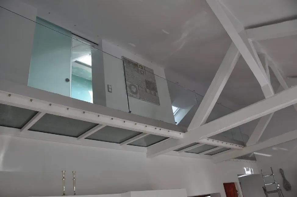 Ein weißer Raum mit Balkon und Glastür