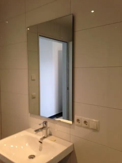 Ein Badezimmer mit Waschbecken und Spiegel an der Wand.