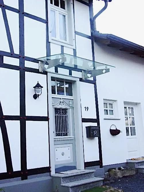 Ein weißes Haus mit der Nummer 15 an der Eingangstür