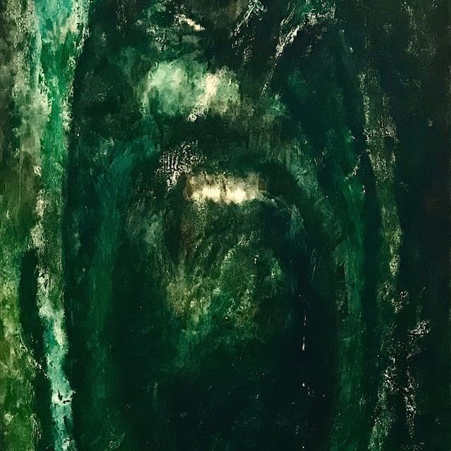 Un primer plano de una pintura verde sobre un fondo negro.