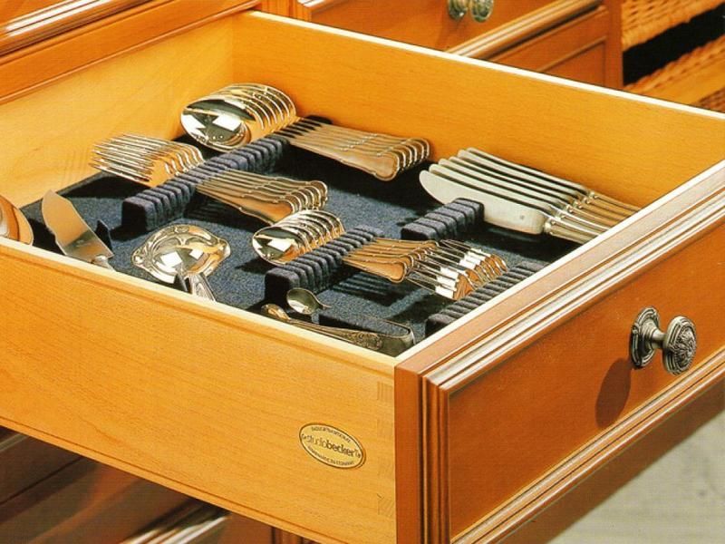 Eine Holzschublade gefüllt mit Besteck, darunter Löffel und Gabeln
