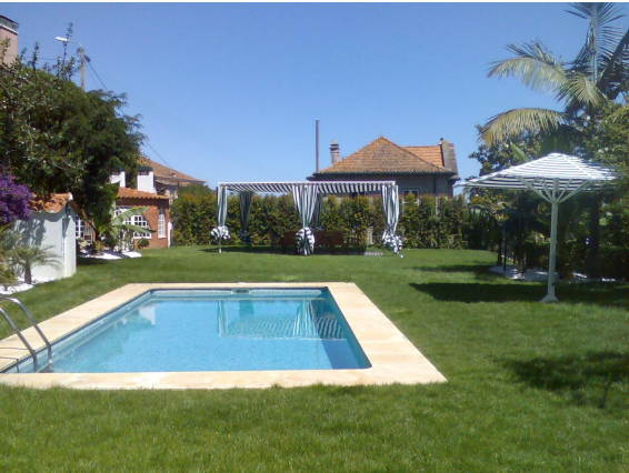 Uma grande piscina no meio de um quintal verdejante