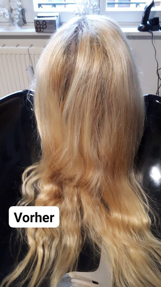 Eine Frau mit blonden Haaren sitzt auf einem Stuhl.