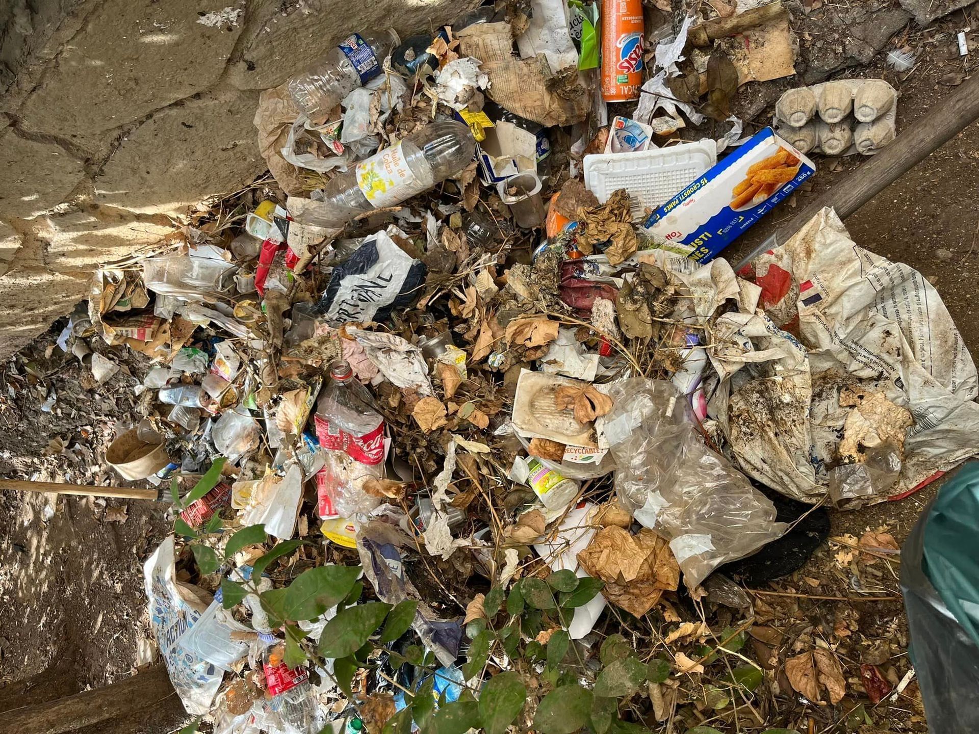 A pile of trash is sitting on the ground.