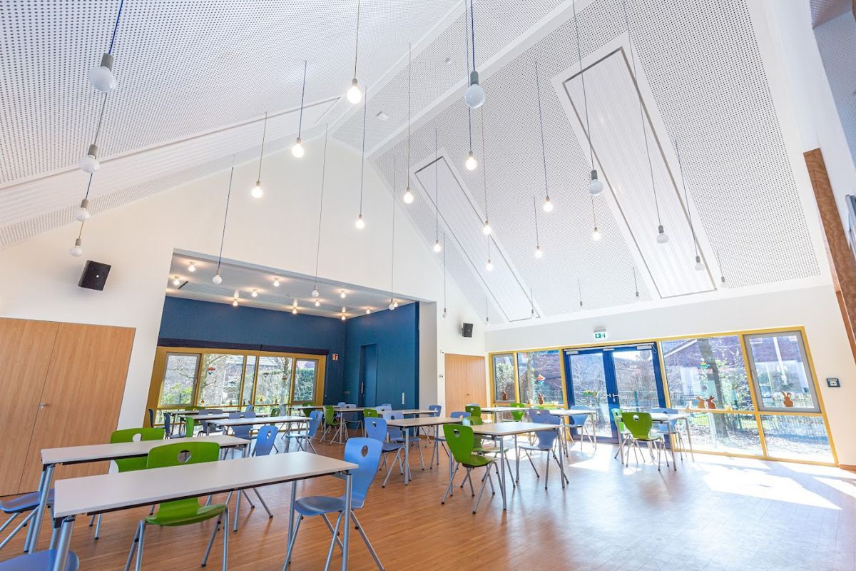 Ein großer Raum mit Tischen und Stühlen.