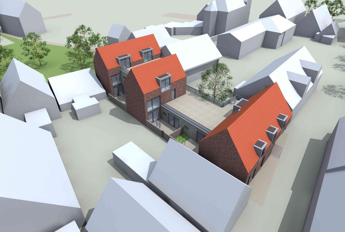 Eine Luftaufnahme einer kleinen Stadt mit roten Dächern