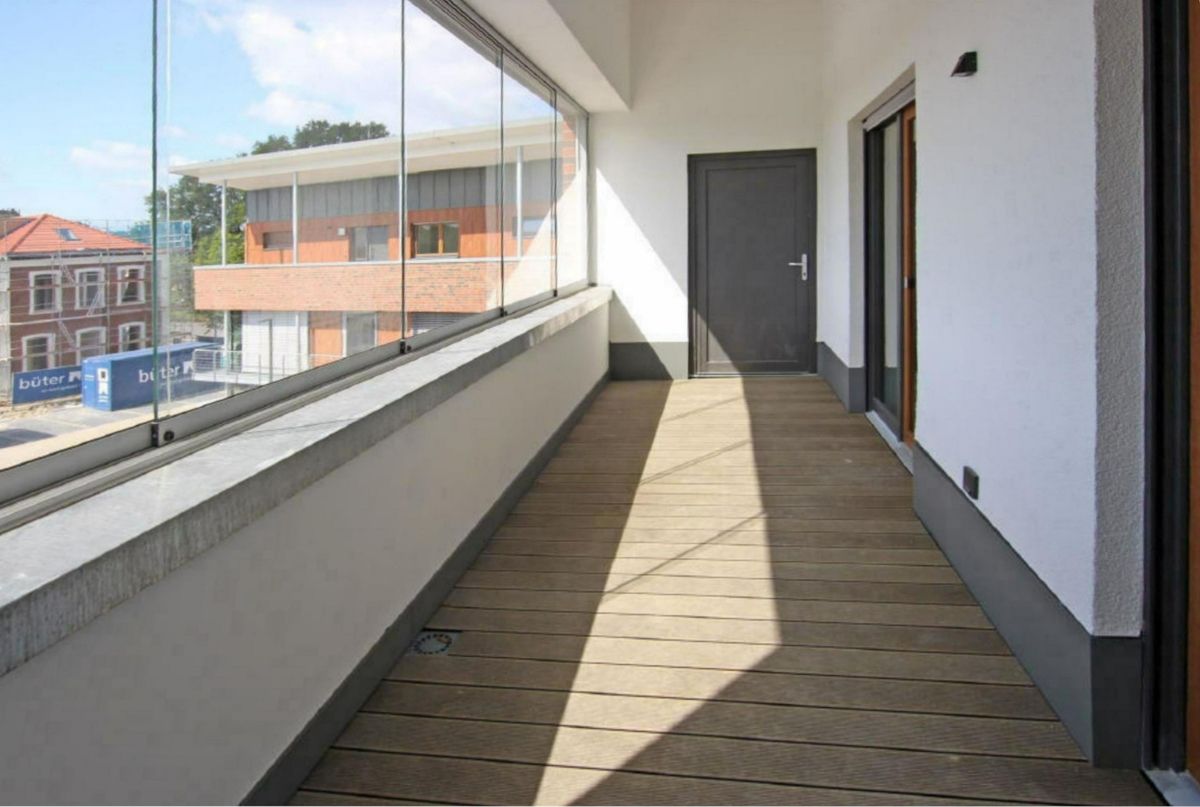 Ein langer Flur mit vielen Fenstern und Türen