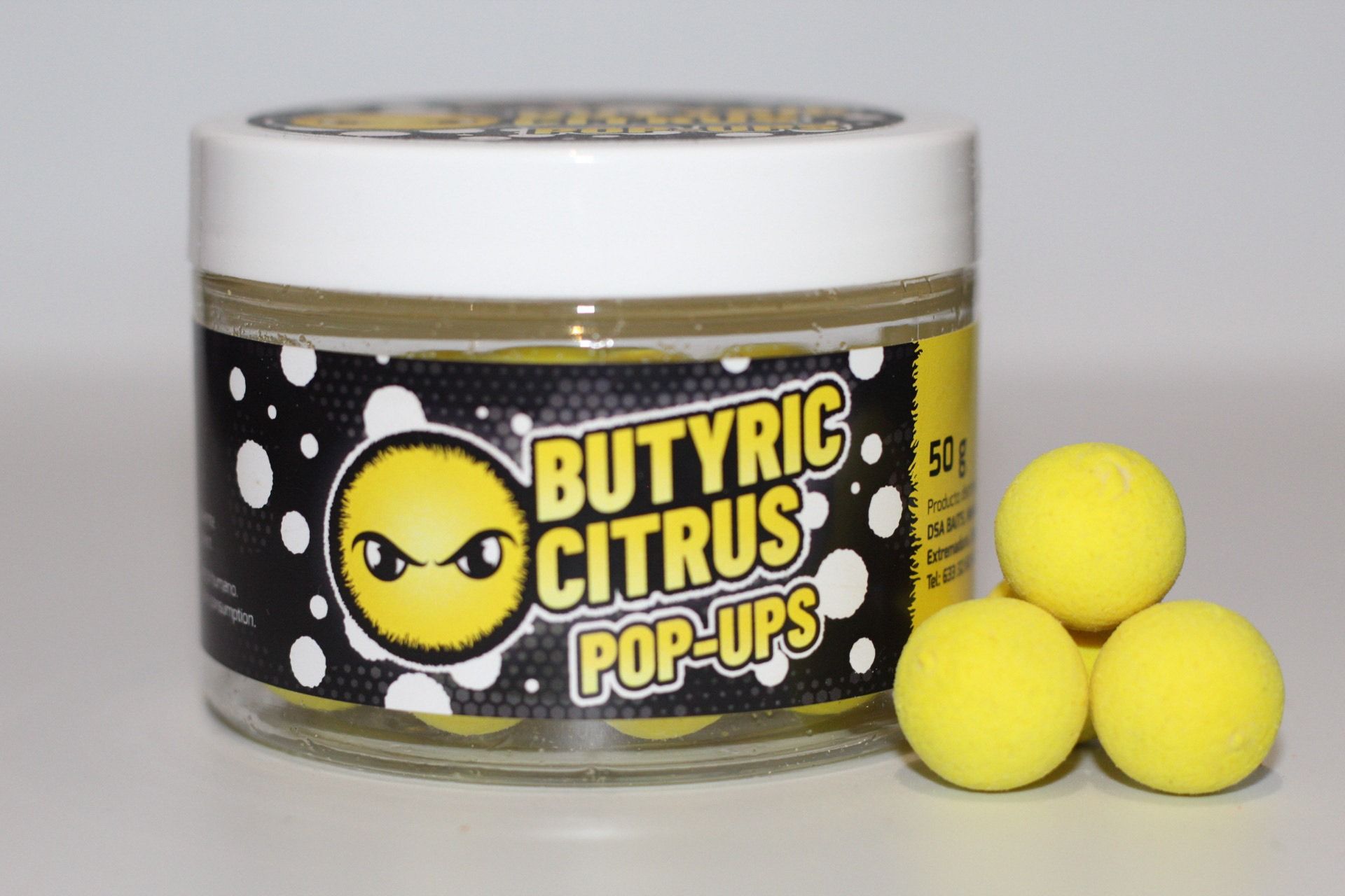 Un frasco de pop ups de cítricos butíricos está sobre una mesa.