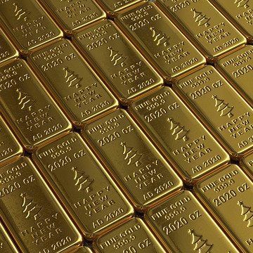 Un primer plano de una pila de lingotes de oro con árboles de Navidad sobre ellos.