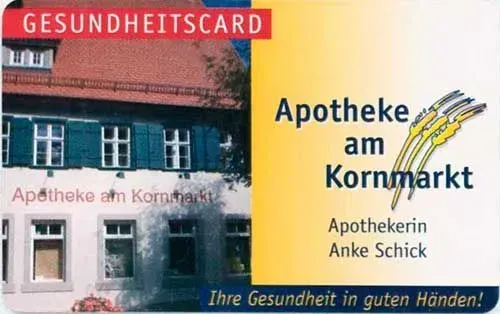 Apotheke am Kornmarkt storefront sign with red “Gesundheitscard” banner and yellow ad panel