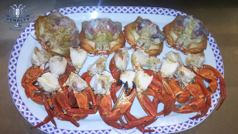 Un plato blanco con cangrejos y alcachofas encima.