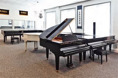 In diesem Raum gibt es viele verschiedene Arten von Klavieren.