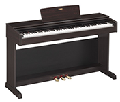 Auf einer weißen Fläche steht ein Digitalpiano.