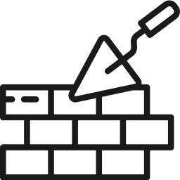 Una paleta está colocada encima de una pared de ladrillos.